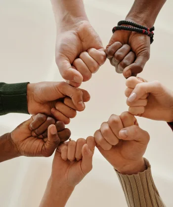 Hands joined in a circle — recovery at Dunamis is built with the family, not alone
